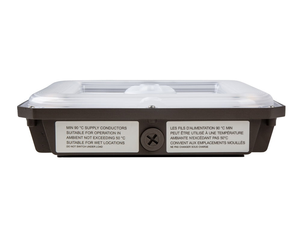 Upside-down side view of the NCLTG CanoLux Series LED Canopy Light highlighting the polycarbonate lens and knockout point for versatile mounting options
