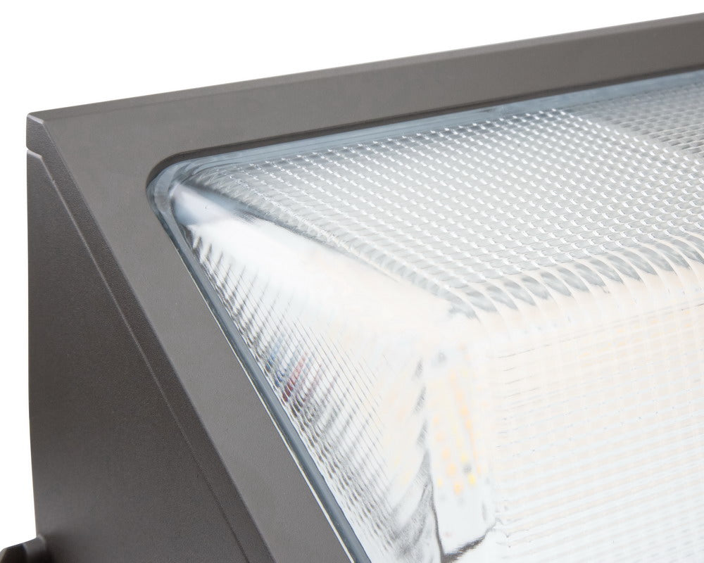 Close-up corner view of the NCLTG WallGuard Series LED Wall Pack Light highlighting the lens and construction details