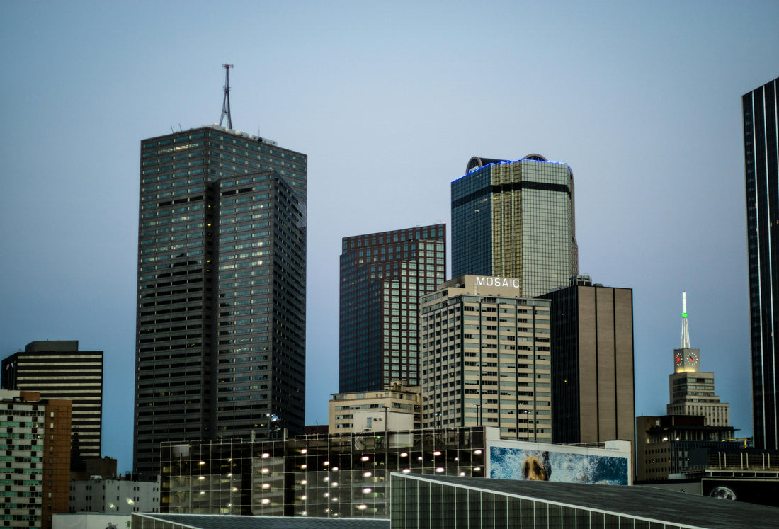 Photo by Danny Meneses — modern curtain glass office buildings in downtown Dallas, Texas, including a black high-rise, under a clear blue sky. Source: Pexels.