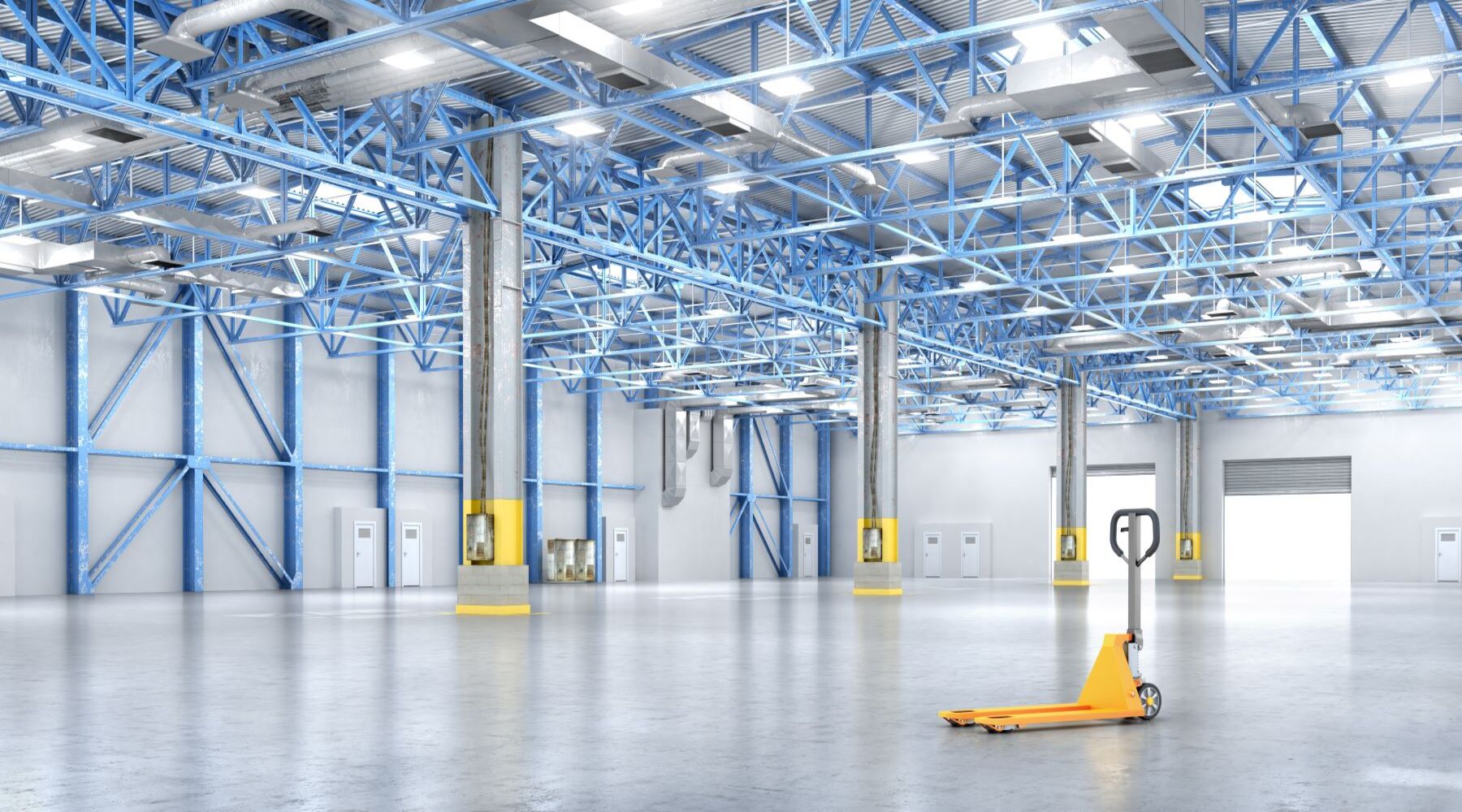 LED Linear High Bay lights suspended above blue steel beams illuminate an empty warehouse with a yellow pallet jack on concrete floors, providing bright and energy-efficient lighting.