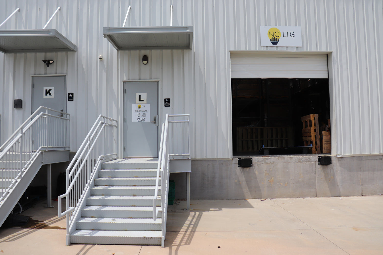Exterior view of the NCLTG Charlotte loading dock with open bays and warehouse access, representing active logistics and distribution operations.